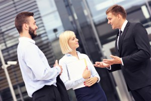 Business people having discussion outside modern building