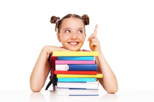 Schoolgirl with books pointing at something